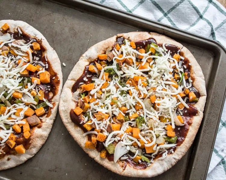 Step 4.1: Top each pita bread with barbecue sauce, then add the roasted veggies, and top with mozzarella cheese