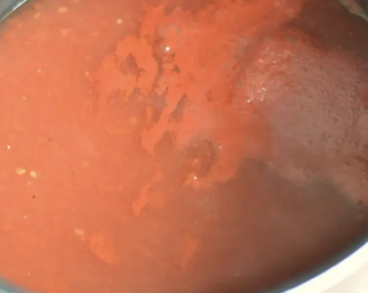 Step 1.1: Add the tomato paste and boil until it turns into a bright red sauce, around 15 minutes