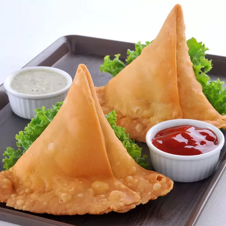 Step 2.1: Fill the cases with a tablespoon of the filling and press the two dampened edges together to seal the top of the cone