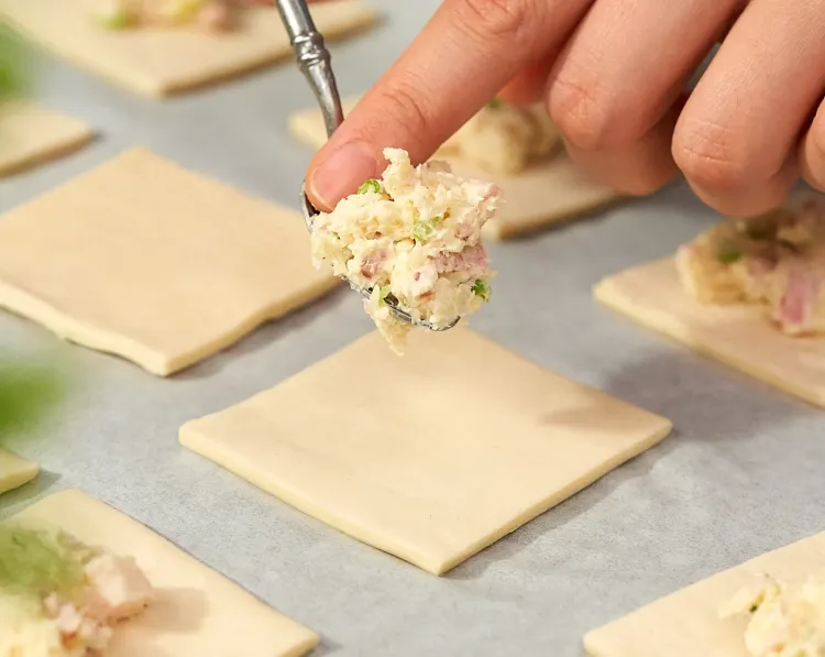 Step 1.1: Top each pastry with a heaping teaspoon of the ham and cheese mixture in the middle
