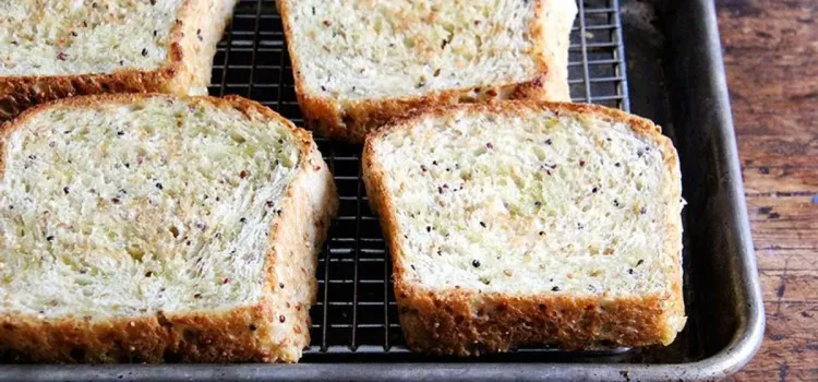 Step 3.1: Remove pan from oven, flip slices of bread over, drizzle with more oil, and return pan to the oven for another 2 minutes, or until bread is golden