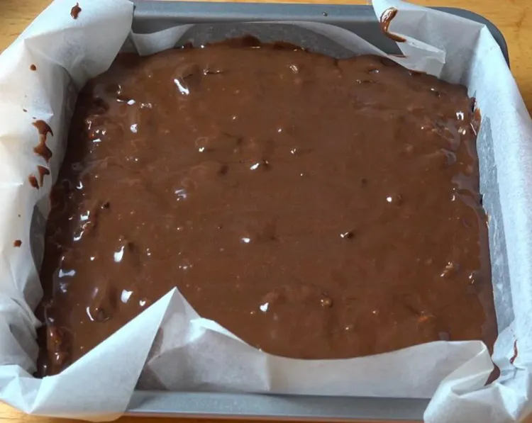 Step 1.1: Transfer brownie batter into a lightly greased 8-inch square cake pan lined with non-stick baking paper
