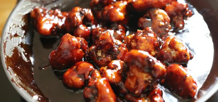 Step 4.1: Working again in batches, quickly add the deep-fried cauliflower to the sauce and toss well