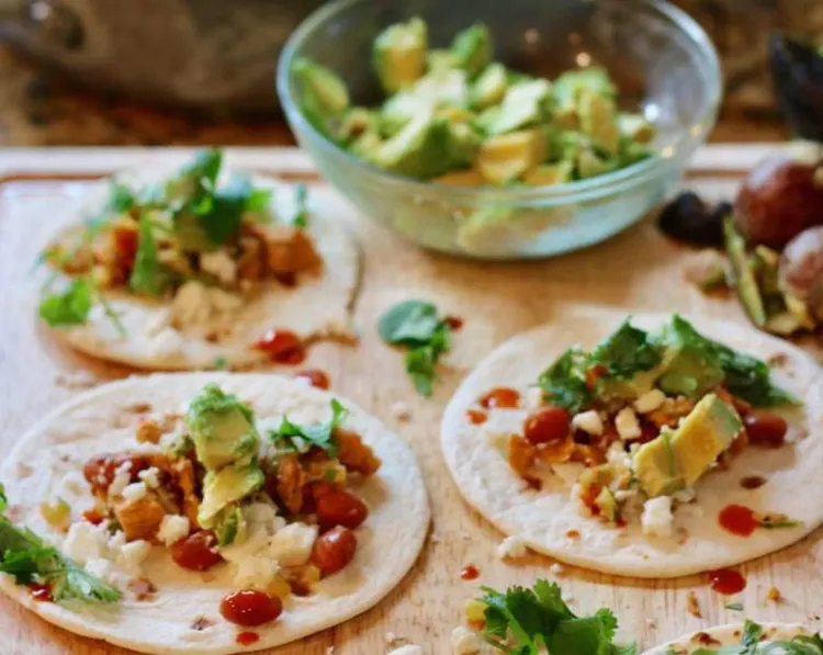 Step 3.1: Lay out the street taco tortillas and divide the mixture evenly on top of each tortilla