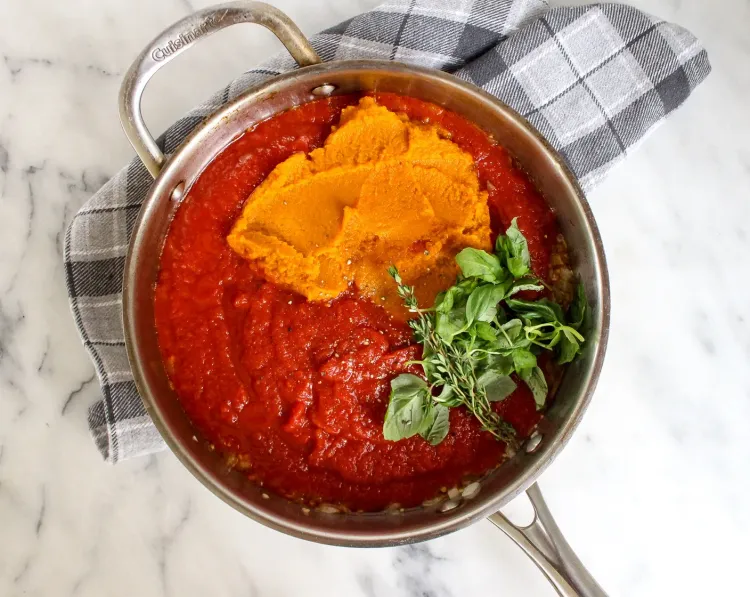 Step 3.1: Add the crushed tomatoes, pumpkin purée, fresh basil leaf, fresh thyme, ground cinnamon, Italian seasoning, ¼ teaspoon salt, and ground black pepper
