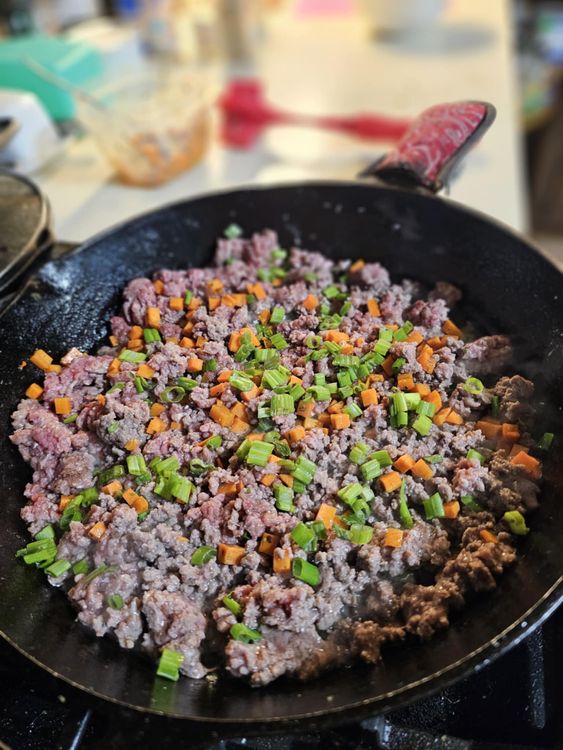 Step 1.1: In a heavy skillet over medium heat, brown ground beef until no longer pink