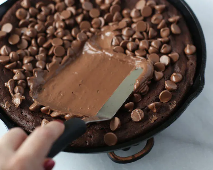 Step 4.1: Remove from the oven and spread the melted chocolate evenly on the brownie