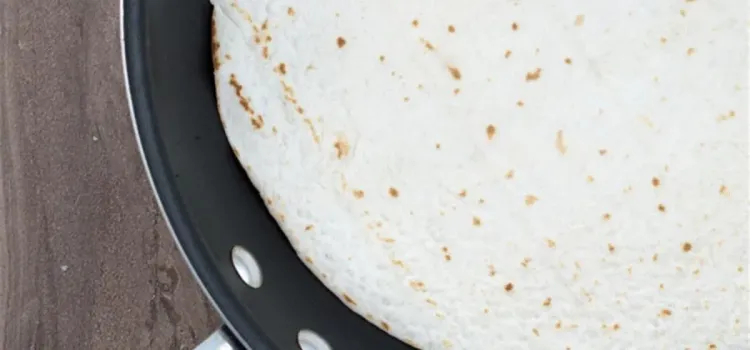 Step 1.1: Heat large flour tortillas in a skillet to make them easier to fold, about a minute on each side