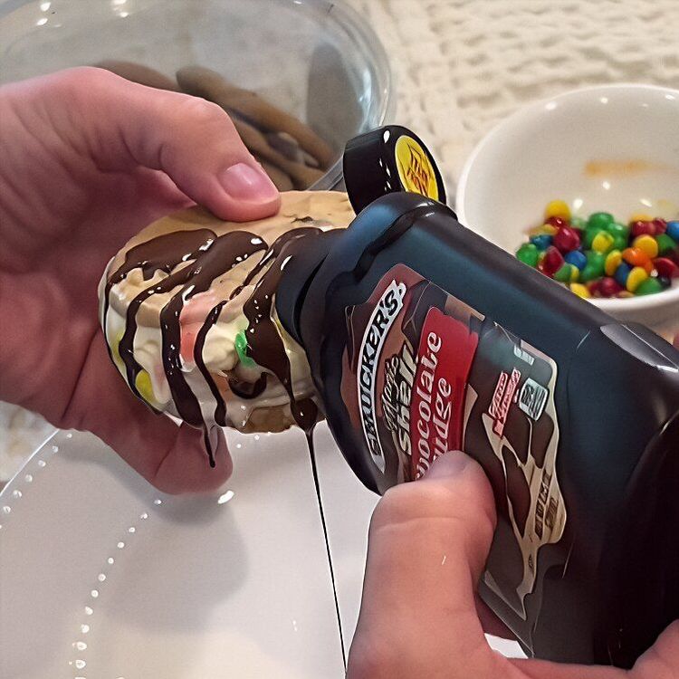 Step 1.1: Roll the edges of the ice cream sandwich in your desired toppings, such as M\&Ms, crushed Oreos, Reese’s, or Magic Shell topping