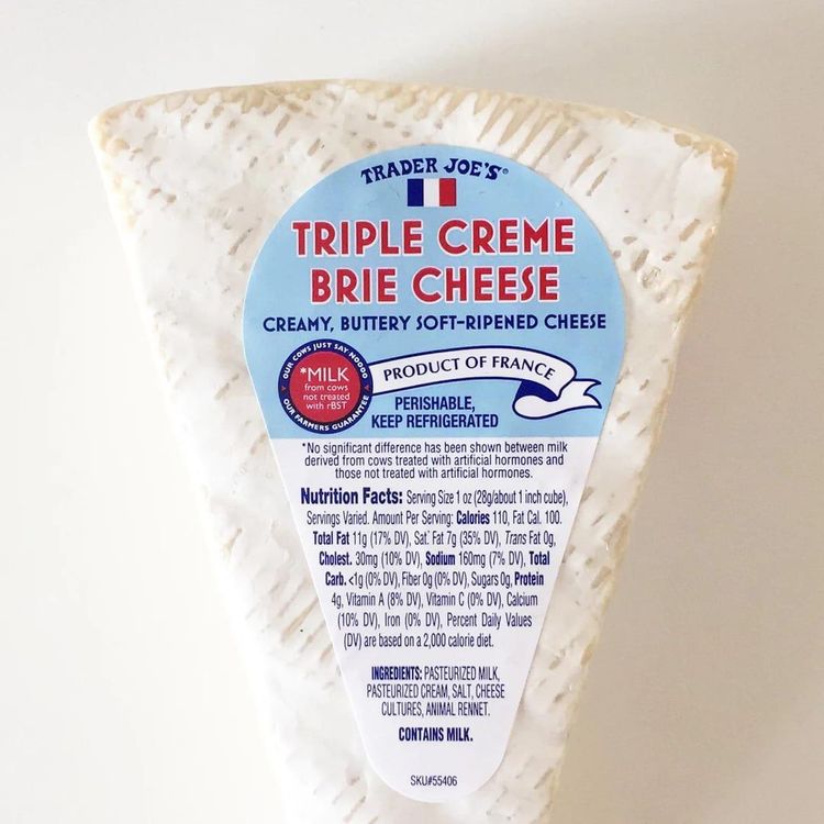 Step 2.2: Cut a few inches of the rind off of the triple creme brie, and generously cover the slice of sourdough with pieces of the creamy brie