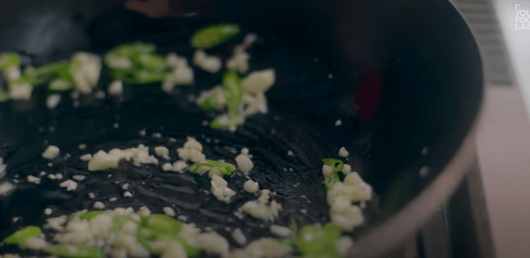 Step 1.2: Add garlic, green chili, and curry leaves