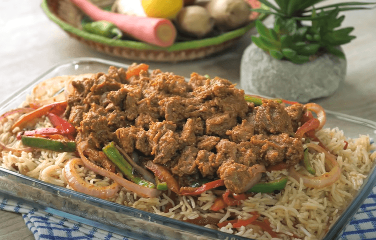 Step 1.1: In a serving dish, add cooked rice, stir-fried vegetables, and cooked mutton