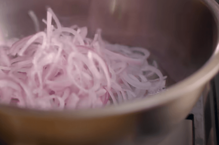 Step 1.1: Set a deep pan over high flame and pour in the oil to fry the onions