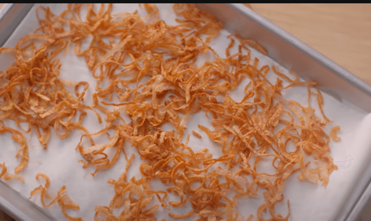 Step 1.1: Once the onions are almost about to turn light golden brown, remove them from the hot oil using a spider and squeeze out the excess oil by pressing it using a spatula
