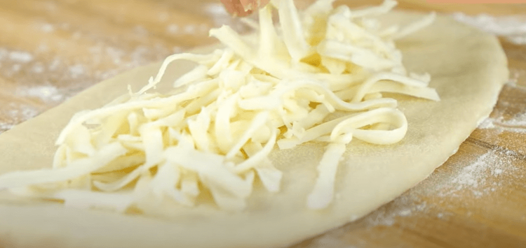 Step 2.2: Stuff with cheddar cheese, pinch, and seal the dough