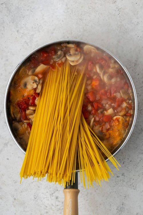 Step 1.1: Add spaghetti noodles and stir until they wilt and fit in the pot