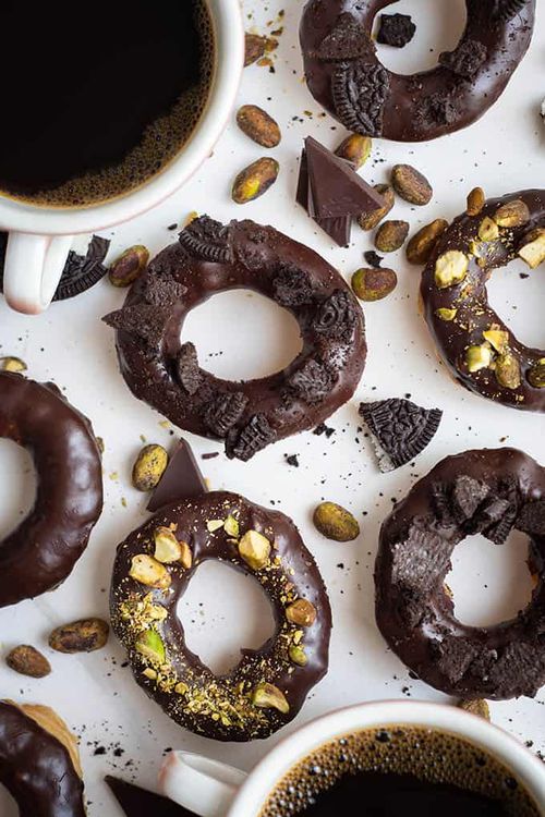 Step 3.1: Once the donuts have cooled enough to handle, dip them in the ganache and let them drip off a bit before returning them to the cooling rack or plate