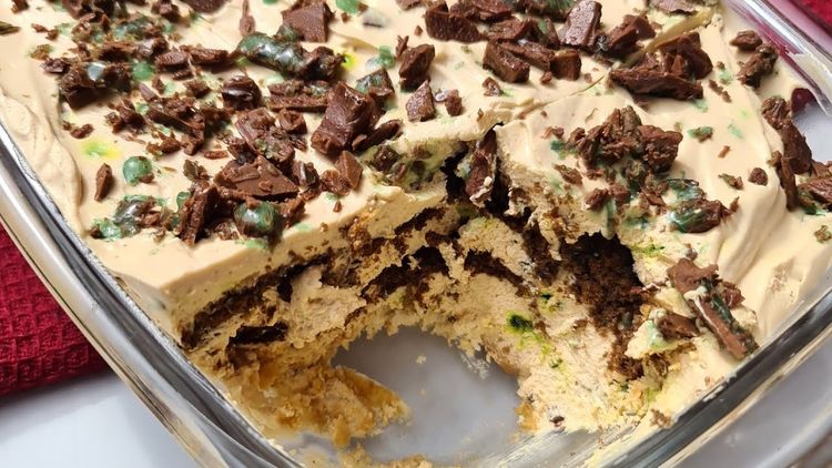 Step 1.1: Grate half of the peppermint crisp over the layer of biscuits