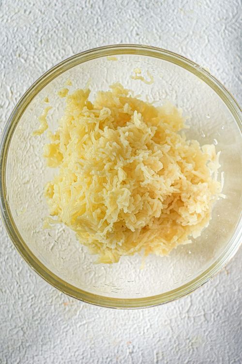 Step 1.1: Transfer the grated boiled potatoes to a large bowl
