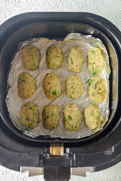 Step 1.1: Place the tots in the air fryer basket and brush them with some oil on top