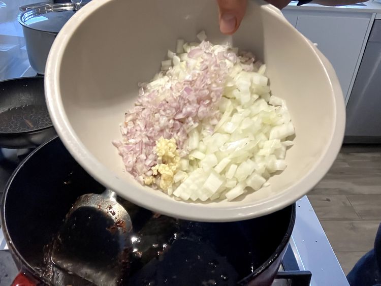 Step 2.1: Let oil cool slightly and then add the shallots, onion, minced garlic, a pinch of salt and squeeze the roasted garlic out of the bulb