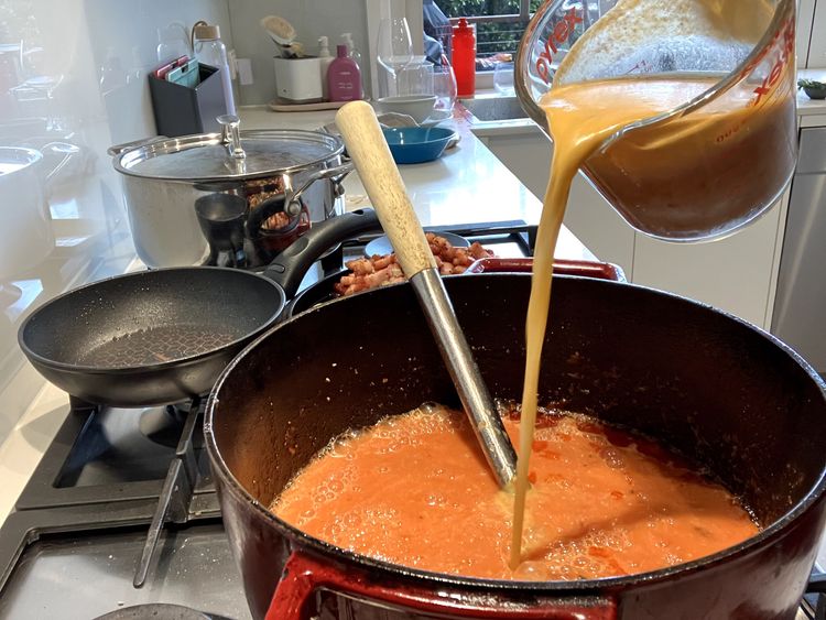 Step 2.2: Add the beef stock, white sugar and tomato puree, mixing everything together
