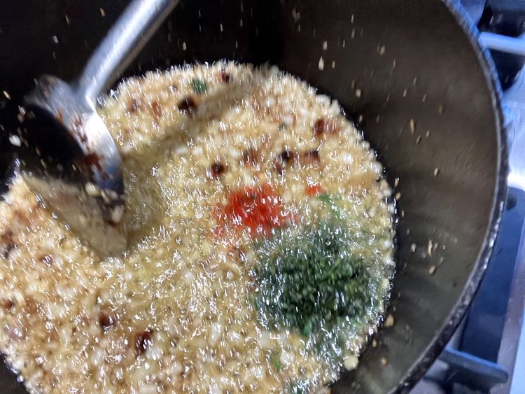 Step 2.3: Add the chillies, basil, and oregano and cook for a further minute, ensuring everything is evenly distributed