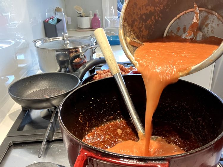 Step 2.1: Add the beef stock, white sugar and tomato puree, mixing everything together