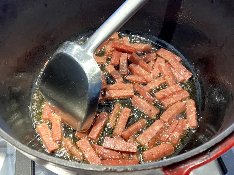 Step 2.2: Heat olive oil over medium-high heat in a heavy-based cast iron pot