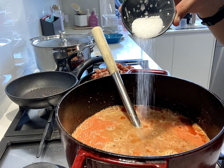 Step 2.3: Add the beef stock, white sugar and tomato puree, mixing everything together