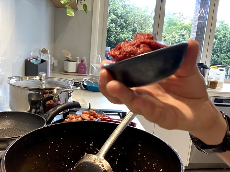 Step 2.4: Add the chillies, basil, and oregano and cook for a further minute, ensuring everything is evenly distributed
