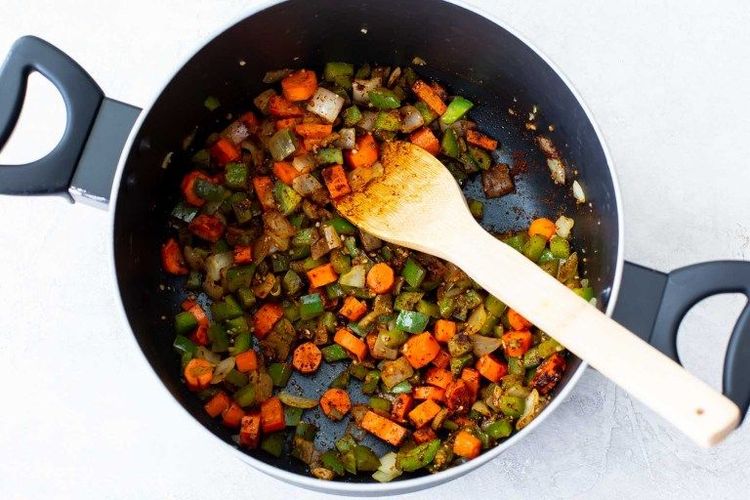 Step 1.1: Add the garlic, chili powder, cumin, and salt to the pan with the vegetables