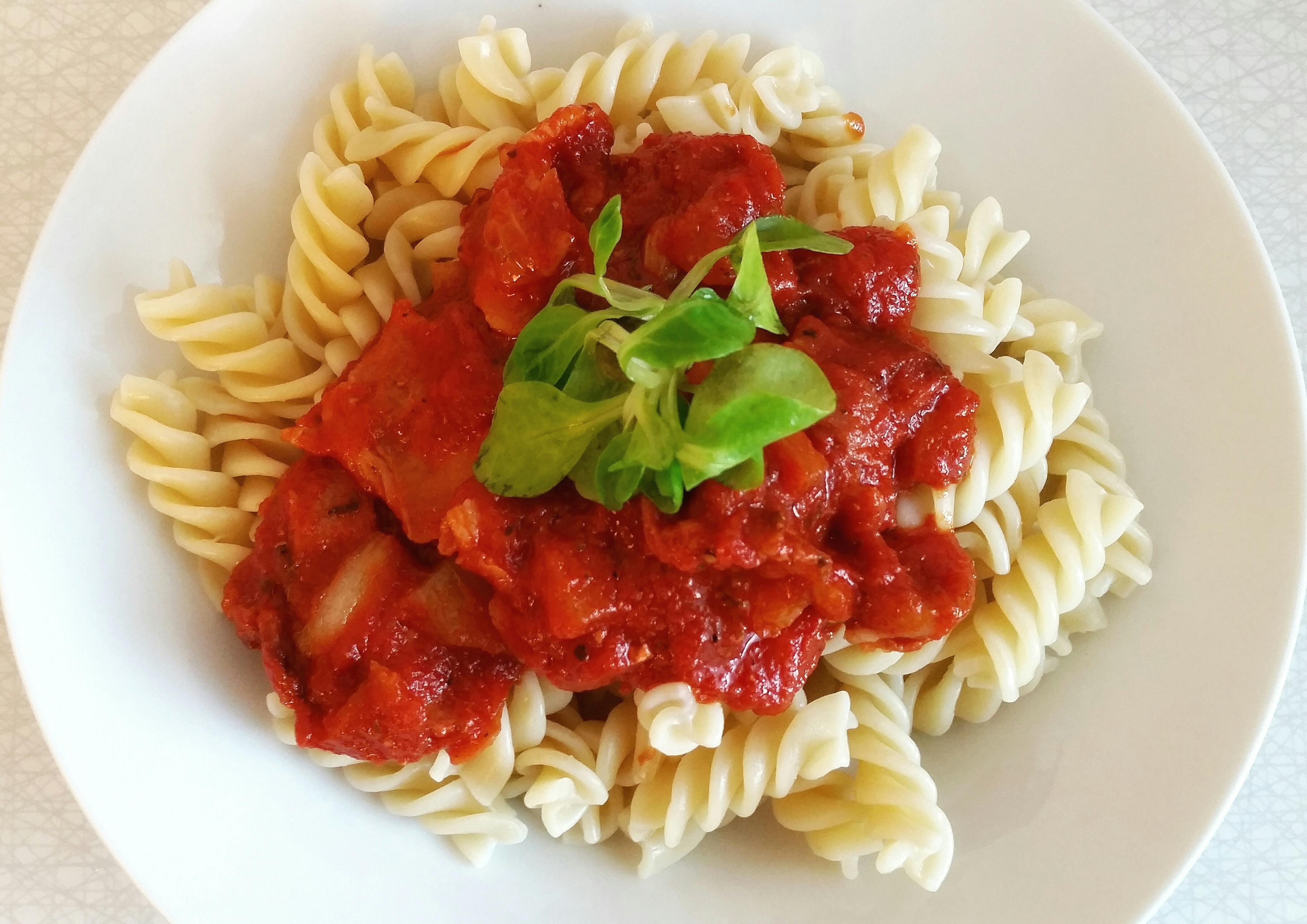 Pasta served with marinara and topped with basil.