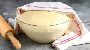 Step 4.1: Place the dough in a greased bowl, cover it with a cloth, and let it rise in a warm place for about 1 hour, or until it has doubled in size