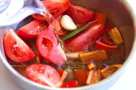 Step 2.1: Add the chopped tomatoes and more broth if necessary to ensure everything is covered
