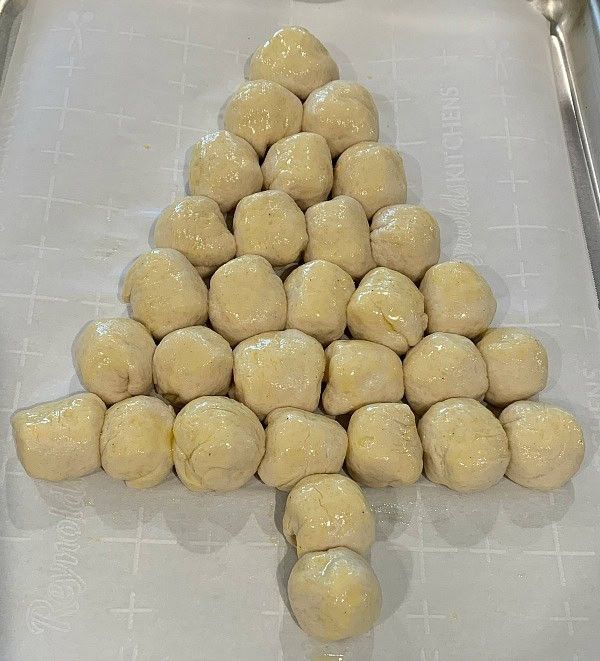 Step 1.1: Place the dough balls on the prepared baking sheet seam side down in the shape of a Christmas tree, ensuring the balls are lightly touching